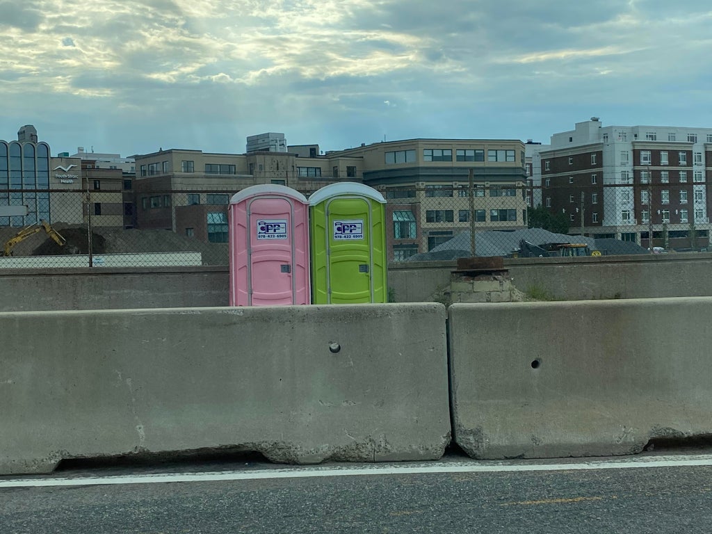 port-a-potties next to the side of the highway