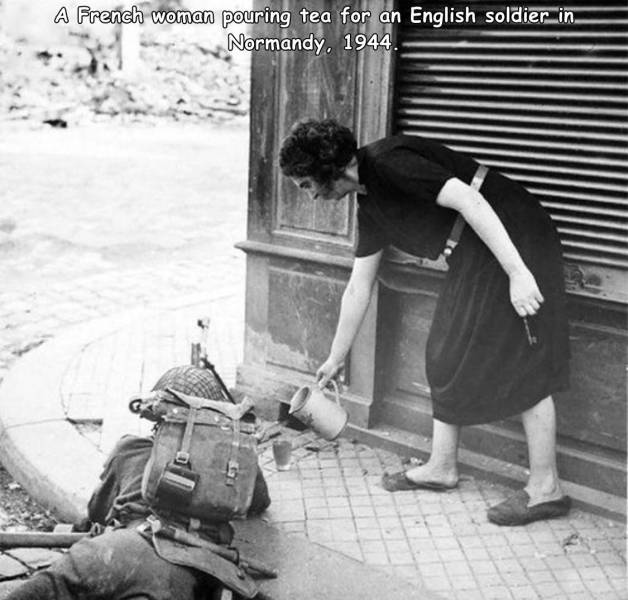 french woman pouring tea for british soldier - A French woman pouring tea for an English soldier.in Normandy. 1944.