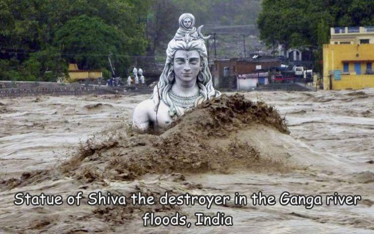natural disasters in india - Statue of Shiva the destroyer in the Ganga river floods, India