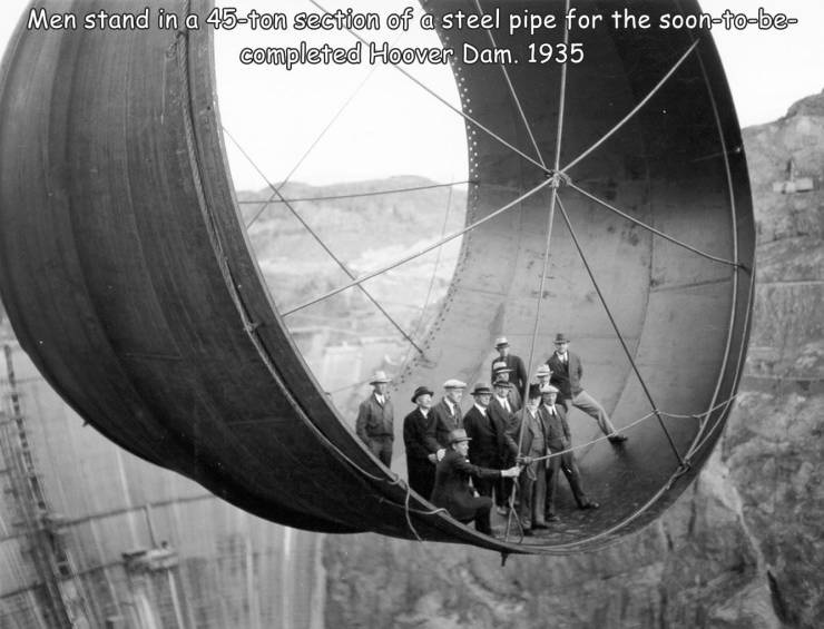 epic photos - many people died building the hoover dam - Men stand in a 45ton section of a steel pipe for the soontobe completed Hoover Dam. 1935