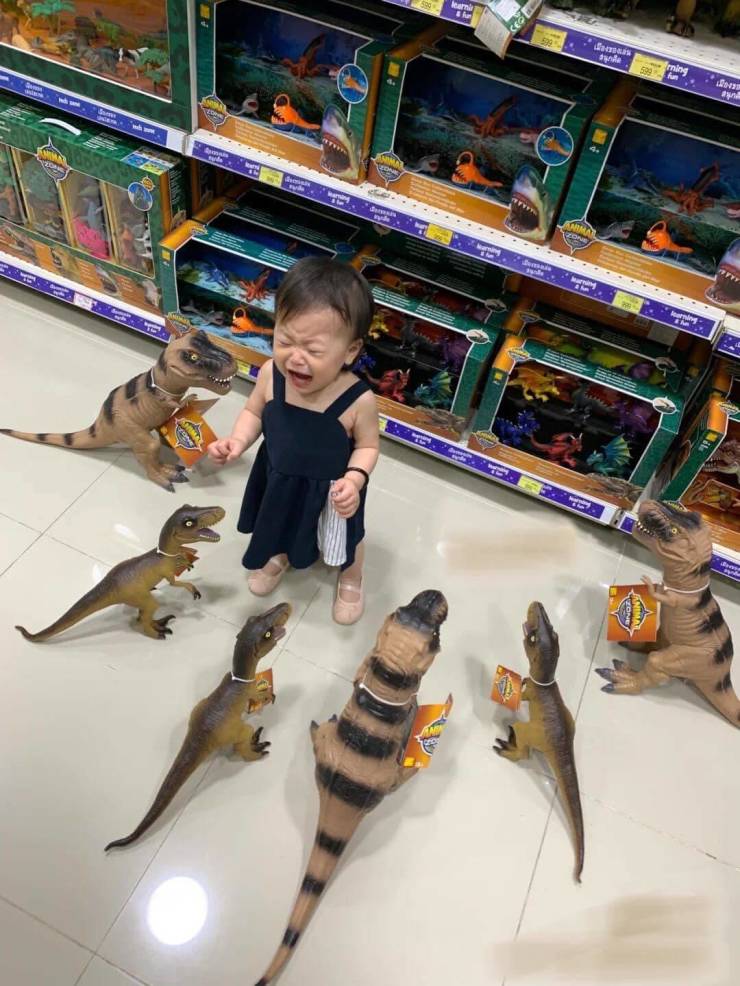 kid surrounded by dinosaurs