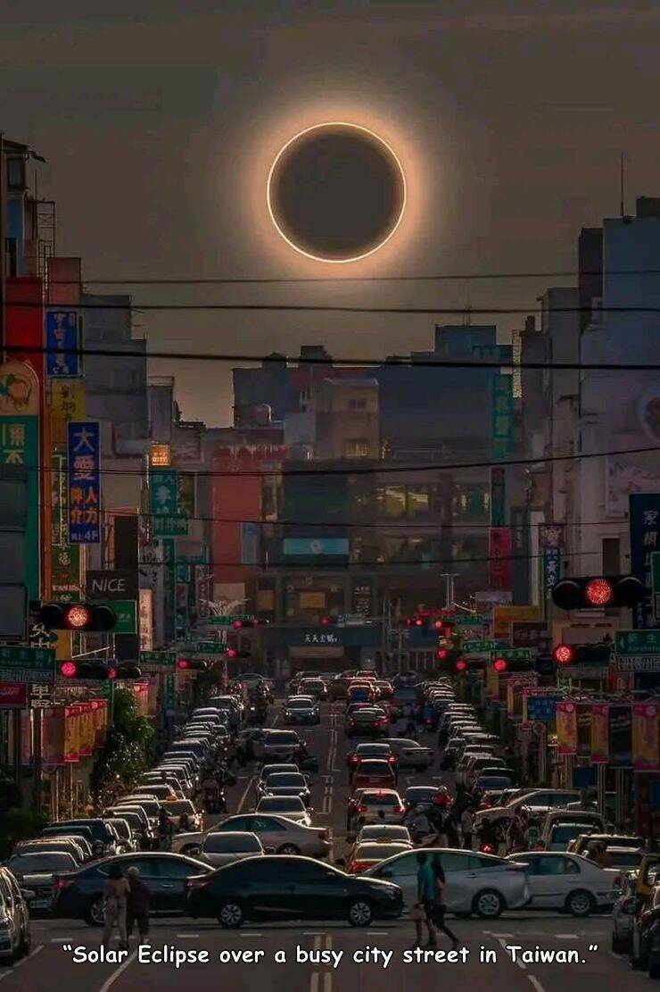 cool random pics - taiwan solar eclipse - K Fera Reaf Mnice "Solar Eclipse over a busy city street in Taiwan."