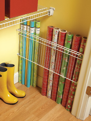 Use a wire shelf to organize rolls of wrapping paper. If you don't have a wire shelf a simple piece of scrap wood or even stretching a bungee cord across the area would work just as well.