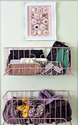 Using command hooks or screw hooks if you don't mind the holes, hang wire baskets on the back of your closet door to store purses, scarves, and other accessories. To save money, search garage sales for older baskets and spray paint them to match your decor.
