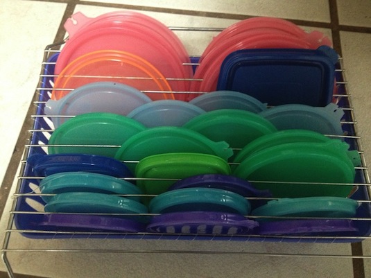 Attach a drying rack to the top of a basket to organize all of those pesky food storage lids. Just thread fishing line through the holes in the basket and over the top of the drying rack to hold it in place.