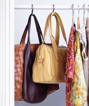 Use shower curtain rods to hang and organize your purses. If you don't have any room on your clothing rod try using a small tension rod in an unused nook or even inside a cabinet.