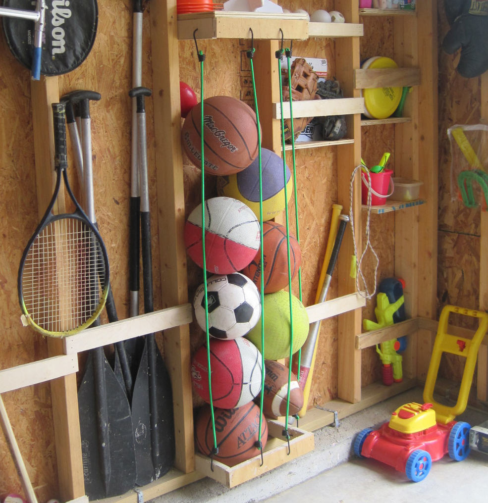 Use bungee cords to corral balls in the garage. Another idea would be to use a similar concept with a section of a book shelf to store stuffed animals or other toys in the playroom.
