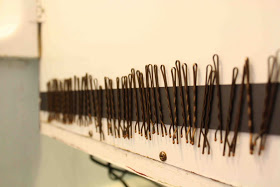 Add a magnetic strip to the inside of a medicine cabinet or cupboard to store bobby pins, nail clippers, and tweezers.