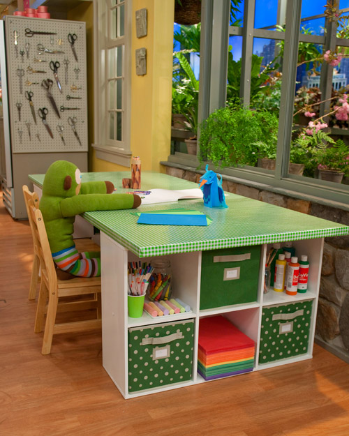 Using a repurposed door on top of cube organizers makes for a simple craft table with lots of storage.