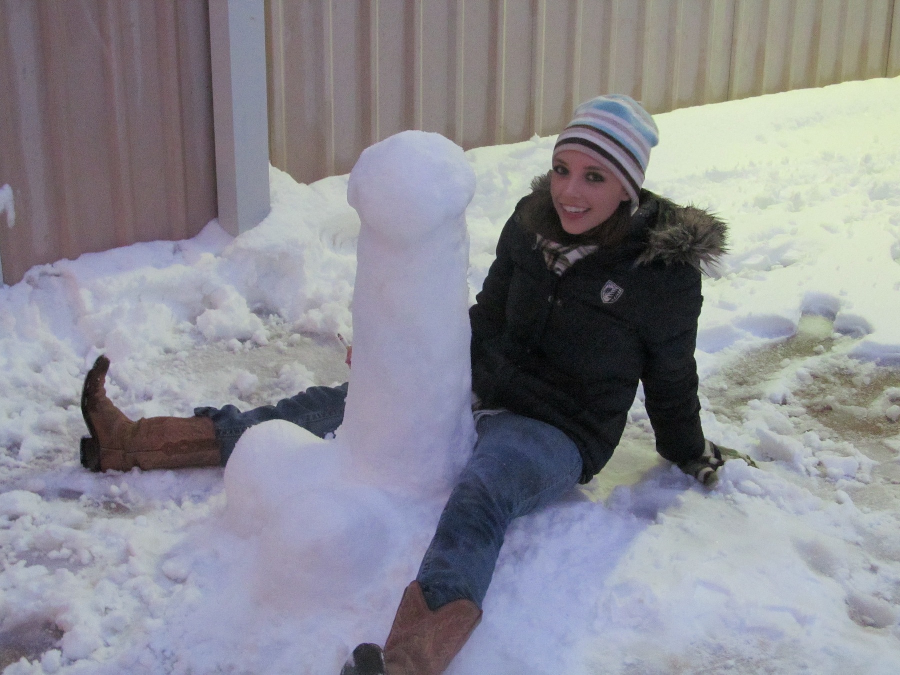 Bored with more traditional snow sculpture, my roommate and I decided to sculpt this snow penis. Here is me posing with our inappropriate art. We built it in the BACKyard. 