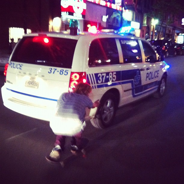 Skater Hangs onto a cop car!