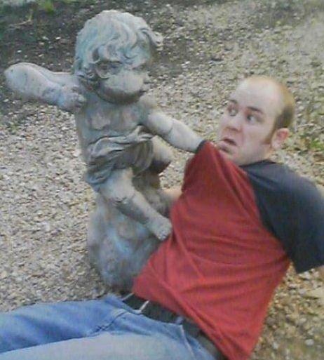 A very awesome pic of a guy and a statue. . .