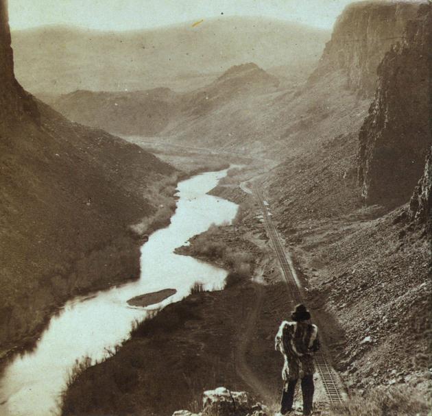 A Native American overlooking the newly completed transcontinental railroad in 1868.