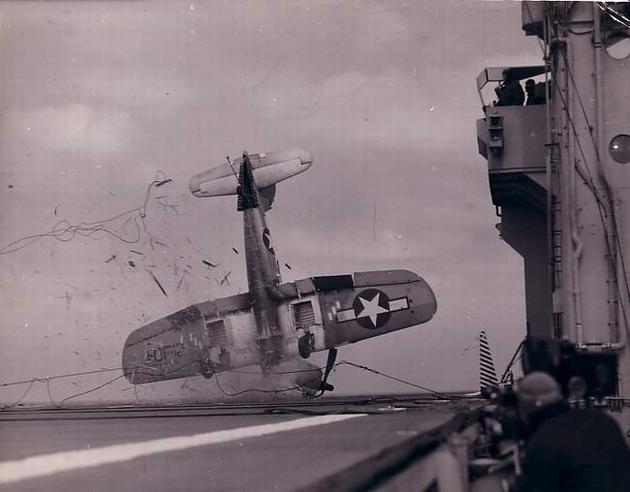 A crash on board an aircraft carrier sometime during World War II.