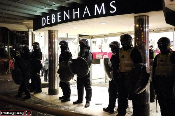 Riot police protect the entrance to Debenhams - Riot police protect the entrance to Debenhams department store in Clapham Junction.
