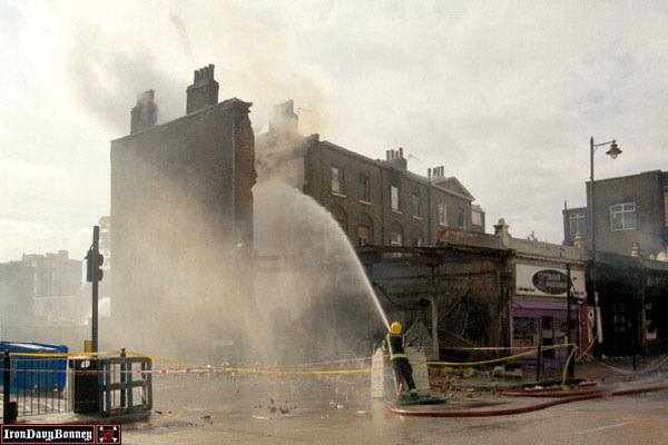 Fire Crews on Site - Emergency services hose down smouldering buildings.