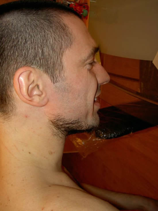 Guy waxes his beard