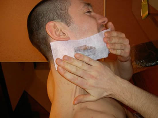 Guy waxes his beard
