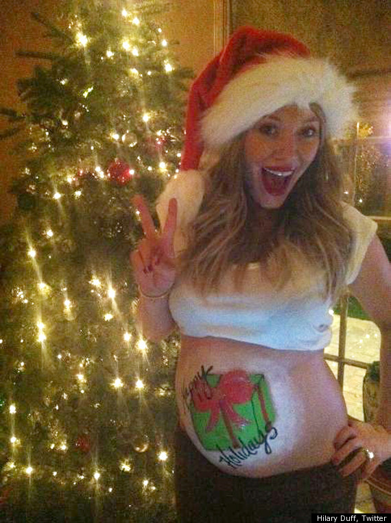 
Her pregnant belly painted Christmas wish. 