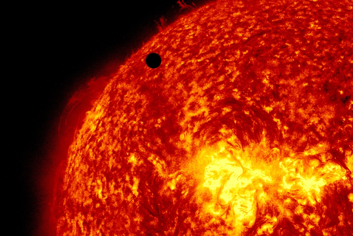 Ultra-high-definition view of Venus, black dot at top center, passing in front of the sun on Tuesday, June 5, 2012