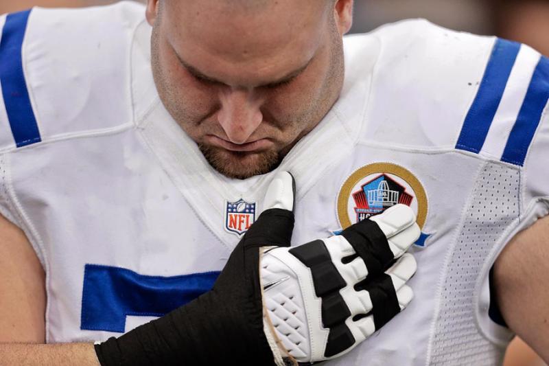 Indianapolis Colts guard Mike McGlynn bows his head during a moment of silence Sunday in Houston