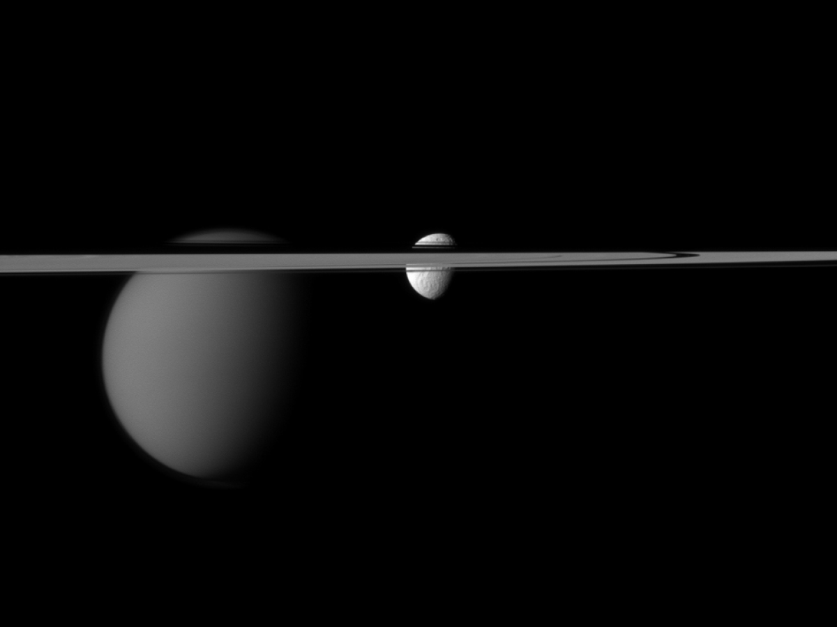 The line of Saturn's rings disrupts the Cassini spacecraft's view of the moons Tethys and Titan.