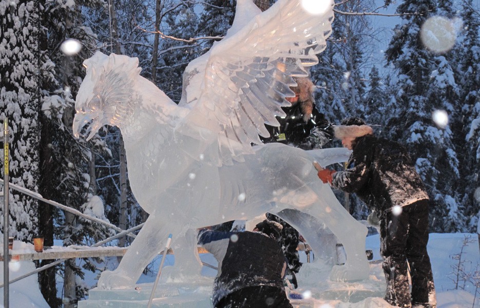 Artists carve an ice sculpture in Fairbanks, Alaska.