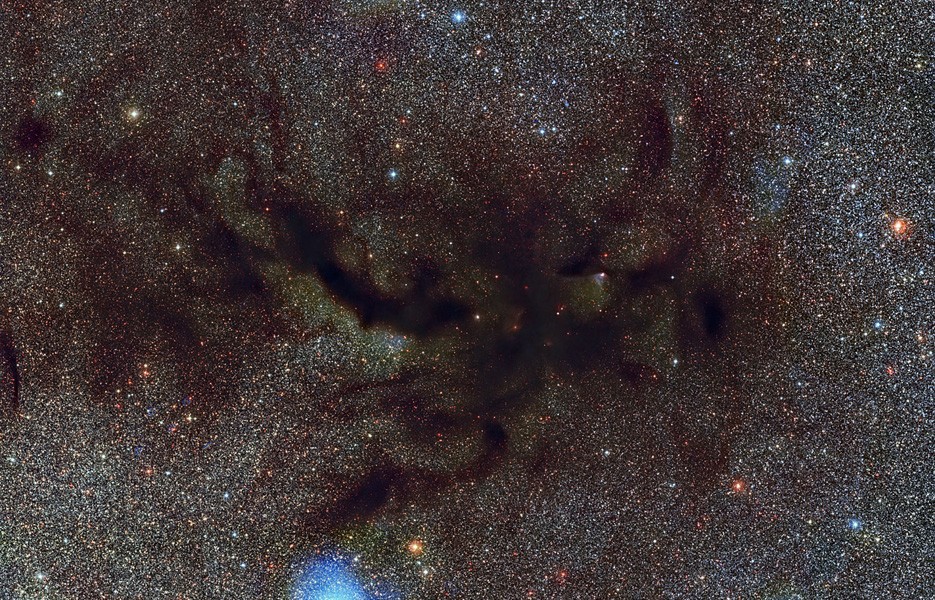 This image shows a part of a vast dark cloud of interstellar dust called the Pipe Nebula
