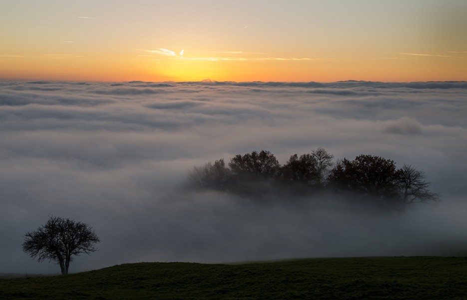 Fog hangs above Lake Geneva at sunset near Lausanne, Switzerland