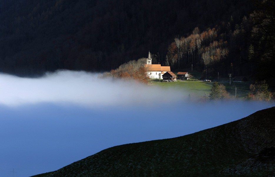 Fog covers a valley near Sachseln, Switzerland.