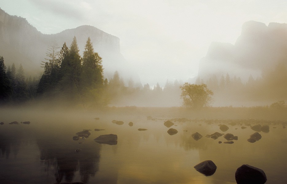 Fog covers a lake in Yosemite National Park in Mariposa County, California.