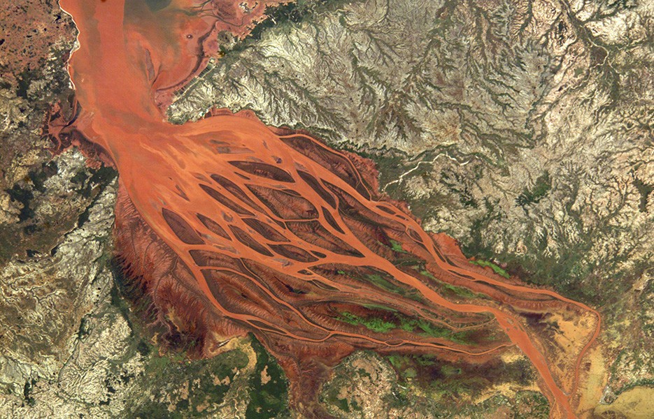 Coastal flooding from Tropical Cyclone Gafilo in Madagascar washed bright orange soil from the hillsides into the Betsiboka River.