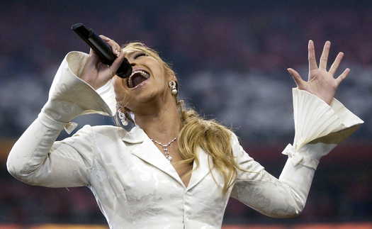 Super Bowl XXVIII  Beyonce tries to shove a microphone down her throat during halftime