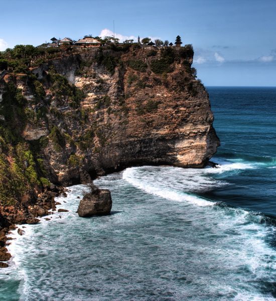 Uluwatu Temple above the Bali Sea, viewed from the temple grounds' northern trail, Bali, Indonesia.