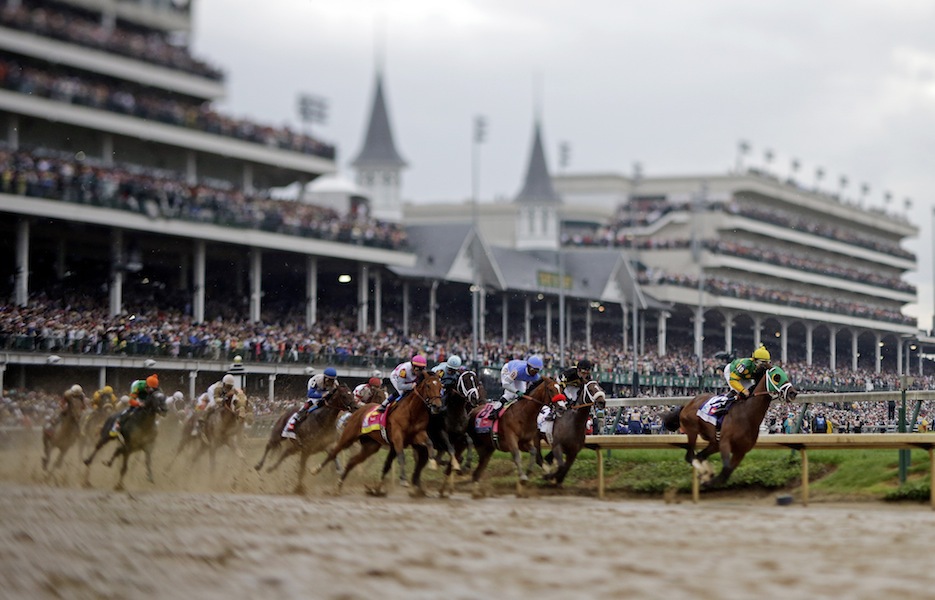 In this image made with a specialty lens, horses make their way around turn one during the 139th Kentucky Derby at Churchill Downs