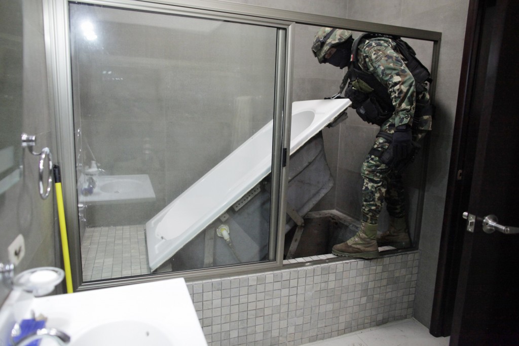 Mexican Marine lifts a bathtub that leads to a tunnel and exits in the city’s drainage system at one of the houses of Joaquin “Chapo” Guzman in Culiacan.