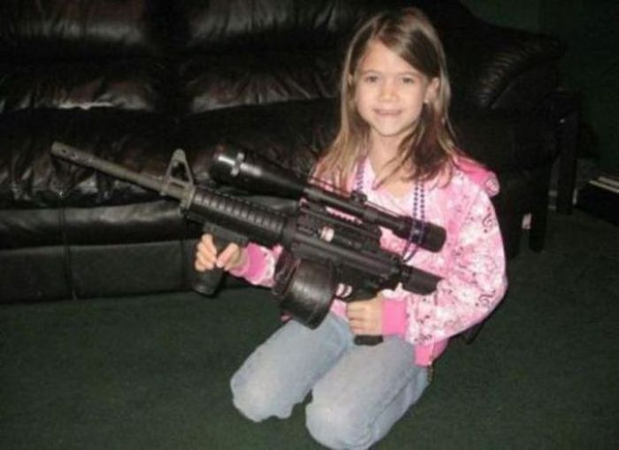 young girl holding gun