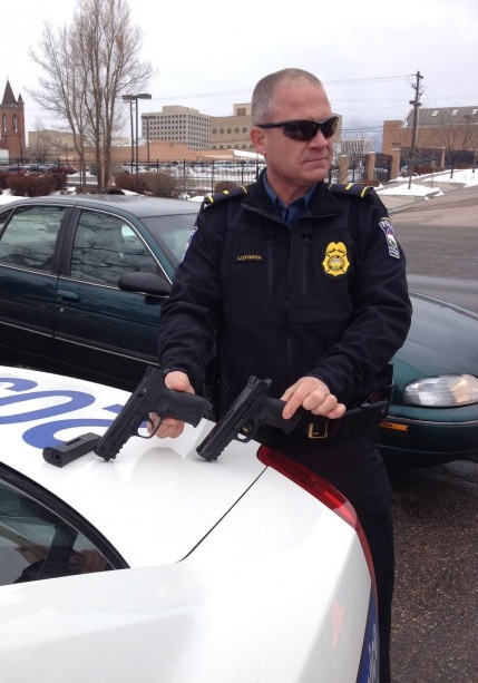 Police Officer compares his firearm to a bb gun recovered during a school fight.