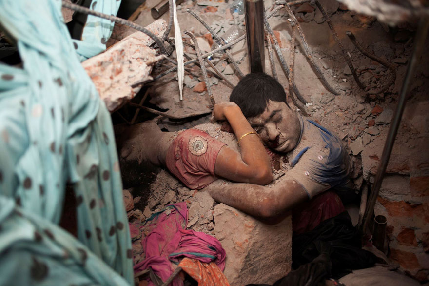Embracing couple in the rubble of a collapsed factory.
