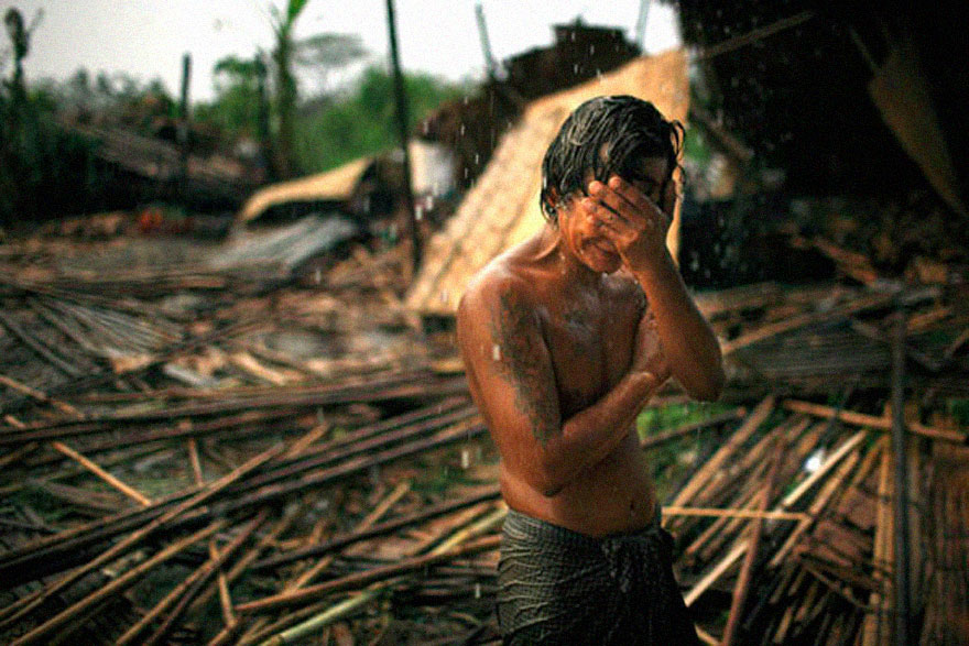 Man sees the rubble of his home after the devastating cyclone Nargis.