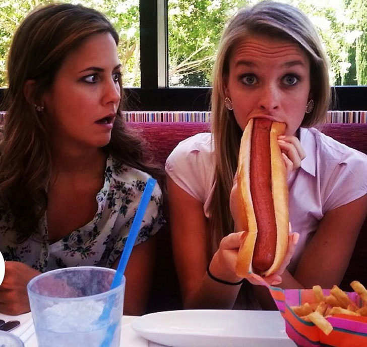 girl eating bratwurst