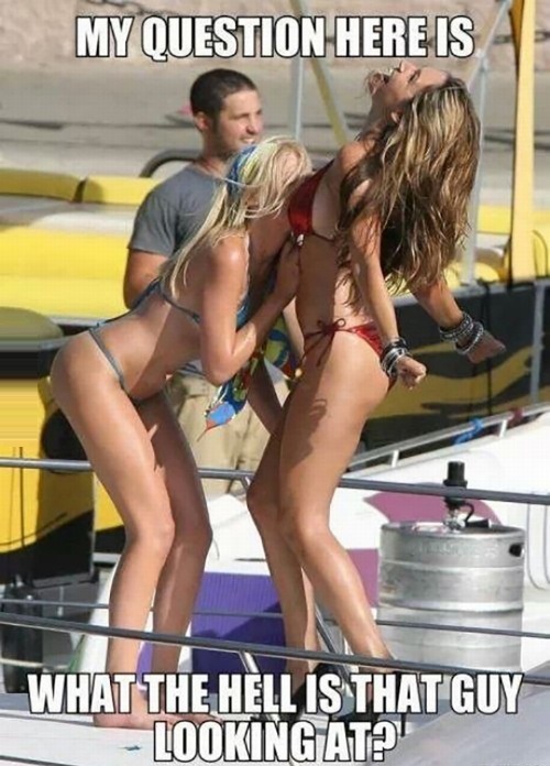 Girls doing body shots and man behind them looking at something else. What is he looking at?