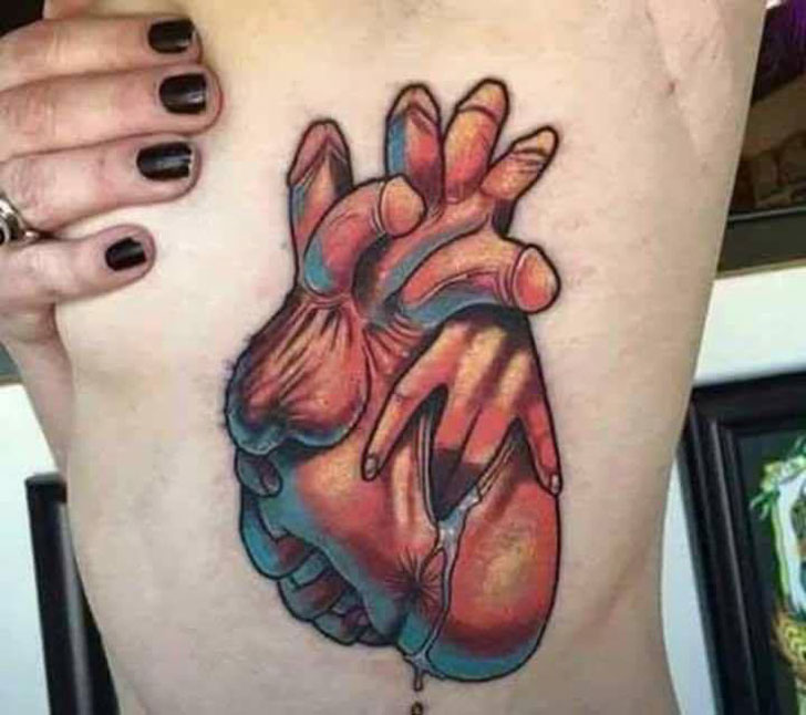 Tattoo of a heart made of dildos being fingered.