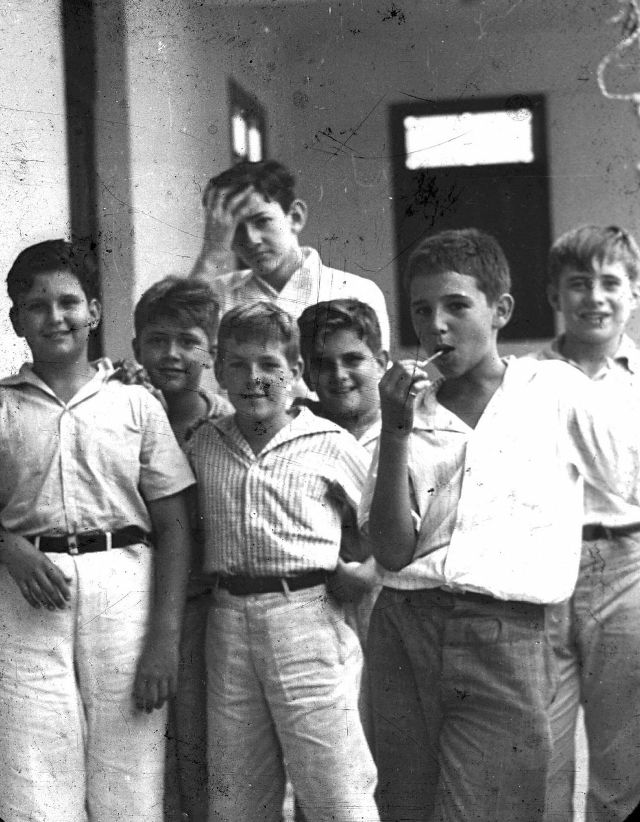 A group of school boys hanging out between classes in Havana, Cuba in 1937. The young man with the lollipop is none other than Fidel Castro.