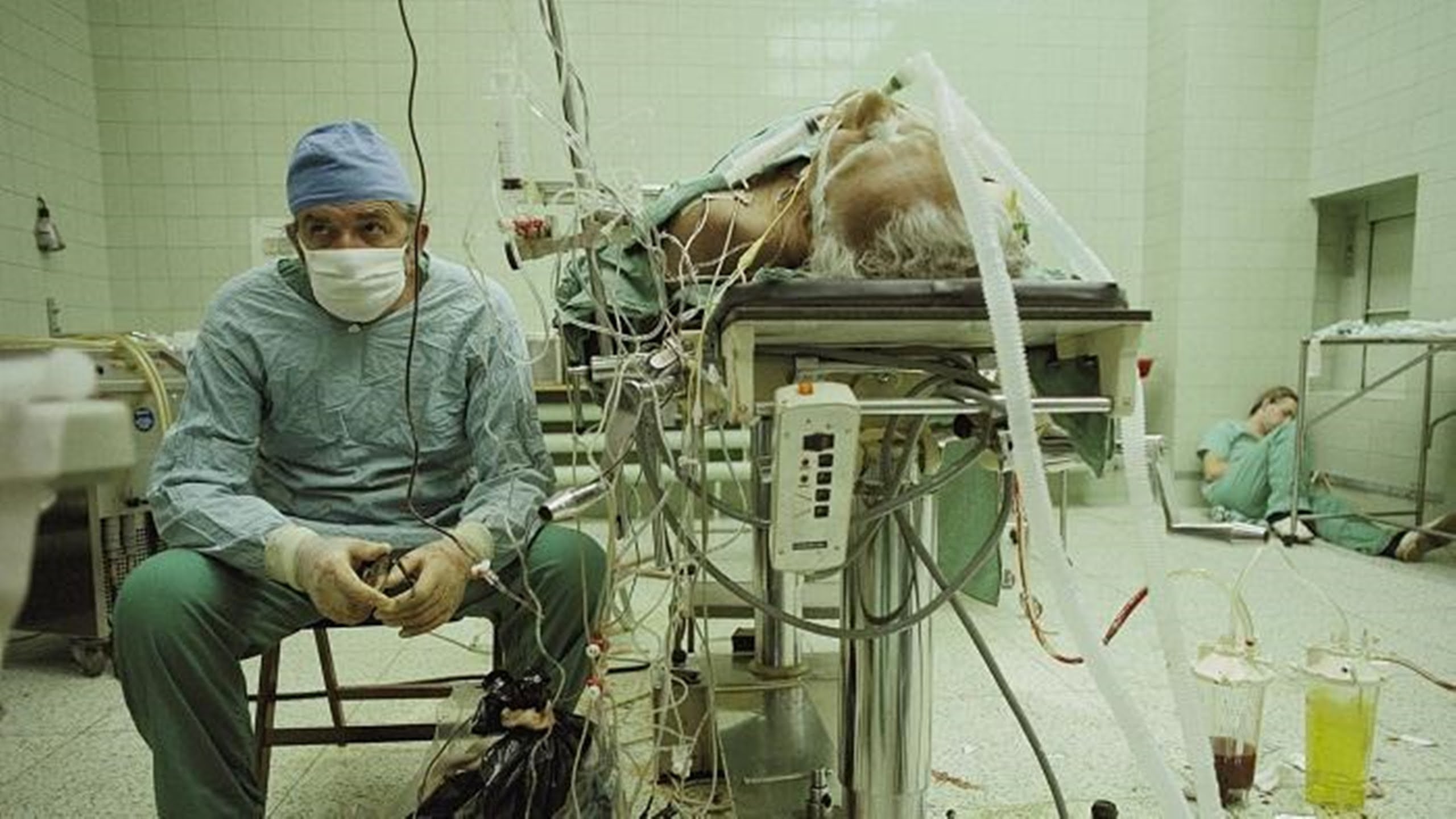 Anxious Eyes -  Taken by James Stanfield in Poland, 1987, this picture depicts cardiac surgeon Zbigniew Religa tracking the vitals of a patient after a successful heart transplant while his assistant rests in the corner. The surgery had taken 23 hours and had used very outdated equipment.