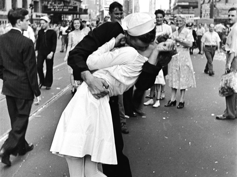 V-J Day Kiss -  Taken on V-J Day on August 14, 1945 by photographer Alfred Eisentaedt and published in LIFE magazine, this infamous picture of a World War II sailor kissing a nurse captured the jubilance people felt upon the war’s end and almost instantly became a cultural icon. The identities of the subjects remained a mystery for decades until they were eventually determined to be George Mendonsa and Greta Friedman. The two didn’t know each other (Eisentaedt later said of that day “There were thousands of people milling around…everybody was kissing each other”), and Mendonsa’s wife Rita can actually be seen smiling in the background of the photo. Many people have come to view the picture as insensitively depicting sexual assault, and not something to be celebrated. Friedman, who died at the age of 92 in 2016, rejected this, stating there was “no way there was anything bad about it.”