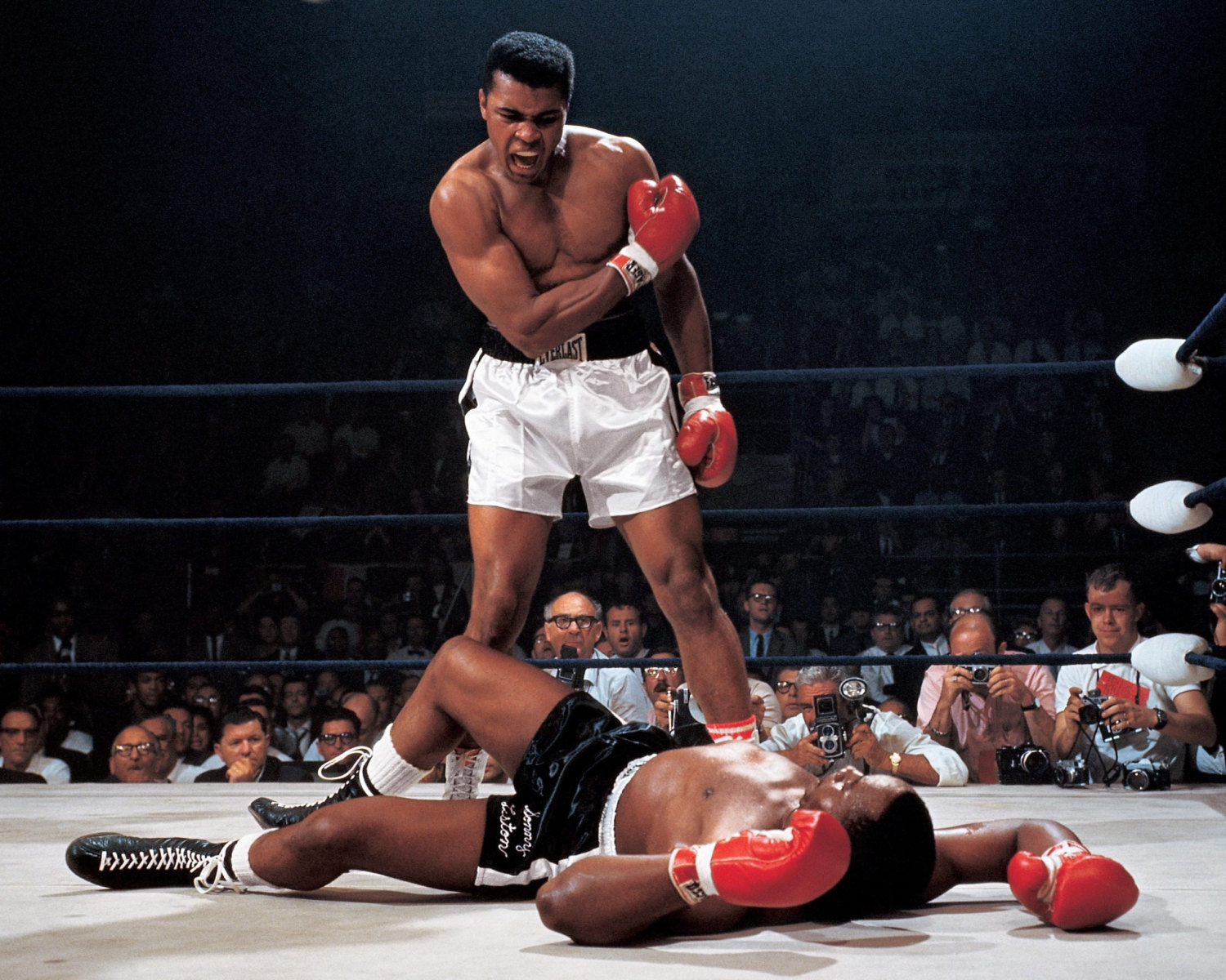 Muhammad Ali vs. Sonny Liston - Sports Illustrated photographer Neil Leifer was in the right place at the right time to snap what is perhaps the greatest sports photo of the 20th century, but he was only there because a senior photographer had arrived before him and essentially forced him to that side of the ring. Leifer was only 22 at the time, and fellow Sports Illustrated photographer Herb Scharfman got there first and pulled rank to claim a prime spot by the judges’ table. Leifer’s seat on the opposite side ended up being perfectly positioned for that historic photo, while Scharfman was stuck shooting toward Ali’s back. Scharfman can be seen in the crowd between Ali’s legs in Leifer’s photo. “It didn’t matter how good Herbie was that day,” Leifer said later. “He was in the wrong seat.”