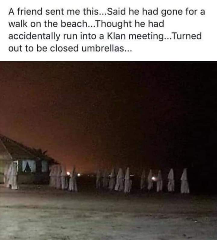 beach umbrellas kkk - A friend sent me this... Said he had gone for a walk on the beach...Thought he had accidentally run into a Klan meeting... Turned out to be closed umbrellas...