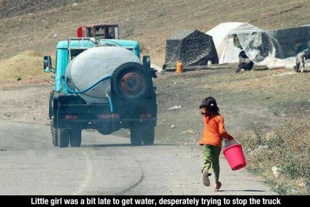 Little girl was a bit late to get water, desperately trying to stop the truck