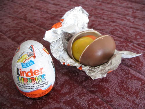 Kinder Eggs are a German candy egg. They have a milk chocolate shell, a white chocolate layer below the shell... and then a hollow center where there's a little toy. Kind of like fortune cookies, if they were more delicious, less preachy and way more of a choking hazard.